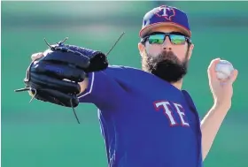  ?? CHARLIE RIEDEL/ASSOCIATED PRESS ?? Rangers ace Cole Hamels, who will be opening his second full season with the team, gets in some throwing during early drills in Surprise, Ariz.