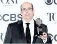  ?? EVAN AGOSTINI/INVISION ?? Christophe­r Ashley poses in the press room with the award for best direction of a musical for “Come From Away” at the 71st annual Tony Awards on Sunday, in New York.