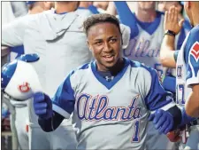  ?? Chris Szagola ?? Atlanta’s Ozzie Albies reacts to his grand slam in the dugout during the third inning of Saturday’s baseball game against the Philadelph­ia Phillies.