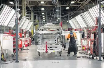  ?? Photograph­s by David Butow For The Times ?? MORE THAN 3,000 Tesla workers dismissed last week were presented with proposed severance agreements as part of the biggest job cut in the company’s history. Above, welders at Tesla’s Fremont, Calif., plant in 2015.