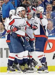  ?? PHOTO] [AP ?? Washington Capitals captain Alex Ovechkin (8) leads the celebratio­n after a goal during the second period of Game 2 of the Eastern Conference finals against Tampa Bay.