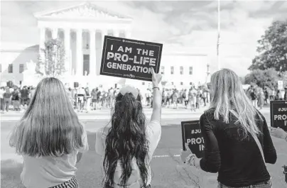  ?? ANNA MONEYMAKER/THE NEW YORK TIMES ?? Protesters with Students for Life of America, an anti-abortion group, stand across the street from a rally opposing Judge Amy Coney Barrett’s confirmati­on in September outside the U.S. Supreme Court in Washington.