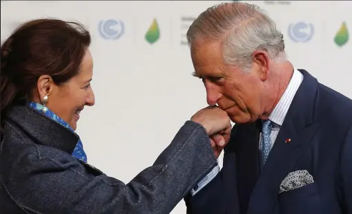  ??  ?? Invitation: Prince Charles greeted by French ecology minister Segolene Royal yesterday