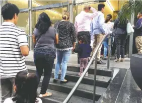  ?? AP FILE PHOTO BY AMY TAXIN ?? People line up June 28 outside the building that houses the immigratio­n courts in Los Angeles.