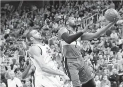  ?? CHRIS NICOLL/ASSOCIATED PRESS ?? Washington Wizards point guard John Wall drives past Utah Jazz center Rudy Gobert. “The refs made us lose this game,” Wall said.