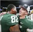  ?? JOHN BAZEMORE — THE ASSOCIATED PRESS ?? Michigan State players embrace after the Peach Bowl.