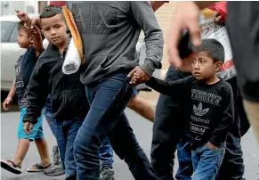  ?? AP ?? Young immigrants arrive with their parents at the Catholic Charities Rio Grande Valley after they were processed and released by US Customs and Border Protection in McAllen, Texas.