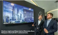  ??  ?? Weidner (right) and Raine look at Mercedes-Benz Malaysia’s first-half 2017 achievemen­ts.