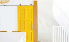  ?? JANIS NICOLAY ?? A door painted yellow features in the ‘light, bright, inviting’ home in Gibsons.