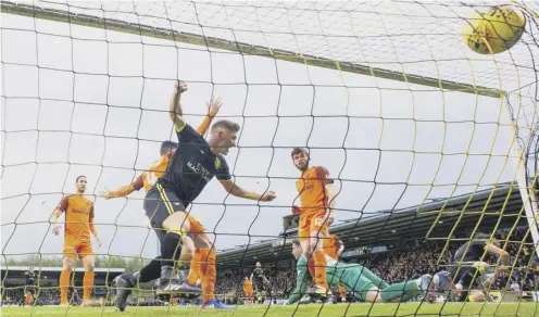  ??  ?? Alan Lithgow, left, heads Livingston into an early lead. United equalised but it was the West Lothian side who reached the Play-off final.