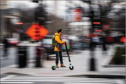  ?? Salwan Georges/The Washington Post ?? An e-scooter zips along a Washington, D.C., street.