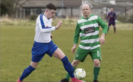  ??  ?? Jordan Muldoon and Garry Rooney in action during Merville v MCR. Pic: Donal Hackett.