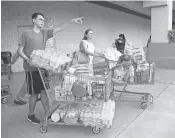  ?? MICHELE EVE SANDBERG, AFP/GETTY IMAGES ?? Shoppers at a Costco in North Miami waited up to eight hours for water and essentials in preparatio­n for Hurricane Irma.