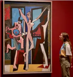  ?? — AFP ?? A woman looking at Pablo Picasso’s The Three Dancers, 1925, during a preview of the exhibition Picasso 1932 - Love, Fame, Tragedy at Tate Modern in London, on Tuesday. The first ever solo Pablo Picasso exhibition remains at Tate Modern for the summer.