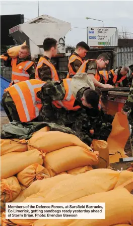  ??  ?? Members of the Defence Forces, at Sarsfield Barracks, Co Limerick, getting sandbags ready yesterday ahead of Storm Brian. Photo: Brendan Gleeson