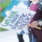  ?? O-D FILE ?? A woman holds a sign before the start of the Take Back the Night event last year. The event is survivor-centered to raise awareness for domestic violence, honor the memory of loved ones lost to domestic violence, and show survivors that they are not alone.