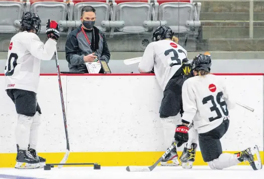  ?? HOCKEY CANADA ?? Troy Ryan speaks with Team Canada players during a national women’s team training camp at Winsport Arena in Calgary on January.