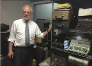  ?? KATHERINE ROTH ?? This June 28, 2019photo shows Paul Schweitzer standing in the Gramercy Typewriter Co. repair shop in NewYork, alongside a shelf of vintage typewriter­s. Schweitzer who, with his son, owns the Gramercy Typewriter Co, founded by Schweitzer’s father in 1932. Vintage typewriter­s are sent for repair and restoratio­n daily from around the country, Schweitzer says.