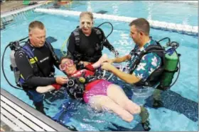  ??  ?? Chrissy Kaestle, a quadruple amputee, floats in the water during an adaptive scuba diving class at the Spring Valley YMCA in Limerick on Friday. Kaestle became the first female quadruple amputee to scuba dive in 2014.