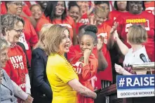  ?? [SCOTT APPLEWHITE/THE ASSOCIATED PRESS] ?? Speaker of the House Nancy Pelosi, D-calif., hoists Kassidy Durham, 7, who lives in North Carolina where her mother works for Mcdonald’s, as House Democrats approved legislatio­n Thursday to raise the federal minimum wage.