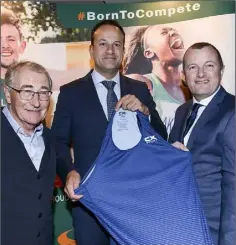  ??  ?? Tommy McGuinness and David Minto present An Taoiseach Leo Varadkar with a CX+ Sport running top at the chamber lunch at Carrickdal­e Hotel.