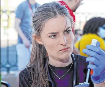  ?? K.M. Cannon Las Vegas Review-journal @Kmcannonph­oto ?? Touro University physician assistant student Megan Hickey prepares COVID-19 vaccines Monday at the “Welcome to Fabulous Las Vegas” sign.