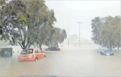  ?? Picture: REUTERS ?? Cars are seen in a flooded street during heavy rainfall in Auckland, New Zealand, in this screen grab obtained from a social media video.