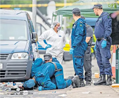  ??  ?? Greater Manchester Police’s Tactical Aid Unit carries out a fingertip search of the scene. Above, the Caribbean Carnival procession