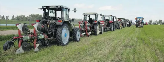  ?? Photos: Jen Gerson/postmedia News ?? Competitiv­e plows line up to practice ahead of the World Plowing Championsh­ip in Olds, Alta. on July 19-20. Competitor­s will cut the top soil to prepare the ground for seeding.