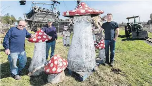  ?? DARREN STONE, TIMES COLONIST | SUBMITTED ?? Dave Gray, left, Ray Galey and Rob Galey show the spot where the giant gnome at right — which has to be moved from its Nanoose site — would make its stand at Galey Farms, sharing a plot with a patch of fibreglass mushrooms.