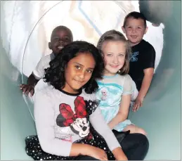  ??  ?? MAKING THE MOST OF THE DROUGHT: Adaya Naidoo leads the way through a piece of cut-off pipe that is now a favourite playground spot, with friends Demi Calitz, Jordan Vermoter and Lionel Masinga. It was acquired from the emergency pipeline to feed...