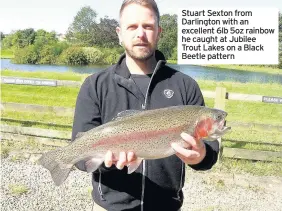  ??  ?? Stuart Sexton from Darlington with an excellent 6lb 5oz rainbow he caught at Jubilee Trout Lakes on a Black Beetle pattern