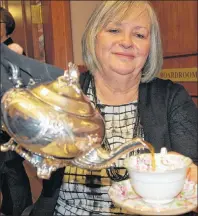  ?? COLIN MACLEAN/JOURNAL PIONEER ?? Josette Martin poured a cup of tea during the annual Mayor’s Tea and Culture/Heritage Awards at city hall in Summerside, Friday.