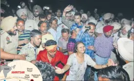  ?? PTI ?? Relatives of victims mourn near the site where a train from Jalandhar ran over Dussehra revellers in Amritsar.