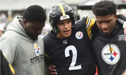  ??  ?? Mason Rudolph is led off the field after being knocked out during his team’s defeat to the Baltimore Ravens. Photograph: Philip G Pavely/ USA Today Sports