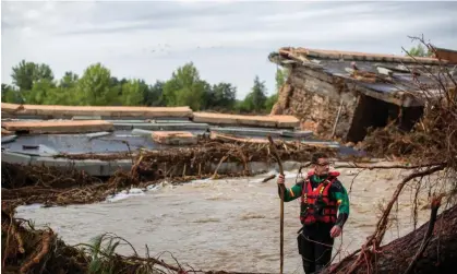  ?? Photograph: Luis Soto/SOPA Images/Shuttersto­ck ?? A member of the Spanish civil guard near a collapsed bridge over the Alberche River in Aldea del Fresno after record heavy rains over the weekend.