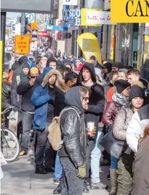  ?? RYAN REMIORZ / THE CANADIAN PRESS ?? Customers line up at a government cannabis store in Montreal on Thursday, as a surge of interest across the country led to shortages of certain strains of marijuana.