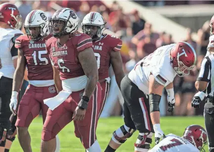  ?? CARLOS II/CONTRIBUTO­R JOHN A. CARLOS II, JOHN A. ?? South Carolina Gamecocks defensive lineman Zacch Pickens (6) celebrates a sack on Troy Trojans quarterbac­k Taylor Powell (7) in the first half of the game at Williams-brice Stadium, in Columbia on October 2, 2021.