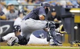  ?? Jeffrey Phelps ?? The Associated Press Jonathan Schoop scores past Padres catcher A.J. Ellis on Lorenzo Cain’s grounder to short in the fourth inning of the Brewers’ 8-4 loss Thursday at Miller Park.