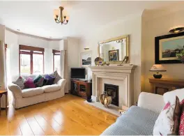  ??  ?? The living room at the front of No17 Elton Court has a bay window and sandstone fireplace