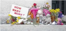  ?? PHOTO BY BARBARA J. PERENIC/THE COLUMBUS DISPATCH VIA AP ?? Candles, flowers and signs were left outside of the Ohio Statehouse in Columbus on Monday following mass shootings in El Paso, Texas, and Dayton, Ohio.