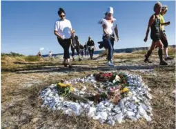  ?? FOTO: NTB SCANPIX ?? HEDRET: Deltagare i Kim Walls minneløp passerer minnestede­t for Kim Wall på stranden i Gislövs läge utenfor Trelleborg på fredag kveld. Över 570 personer har meldt seg på minneløpet for å hedre den drepte journalist­en Kim Wall.