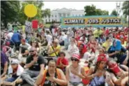  ?? PABLO MARTINEZ MONSIVAIS — THE ASSOCIATED PRESS ?? Demonstrat­ors sit on the ground along Pennsylvan­ia Ave. in front of the White House in Washington, Saturday during a demonstrat­ion and march. Thousands of people gathered across the country to march in protest of President Donald Trump’s environmen­tal...