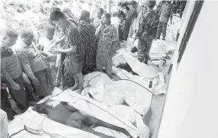  ?? AFP PHOTO ?? Bodies of victims who died in a fire in a garment factory are lined up in Savar on Sunday. Rescue workers in Bangladesh recovered 109 bodies on Sunday after a fire tore through a garment factory, forcing many workers to jump from high windows to escape...