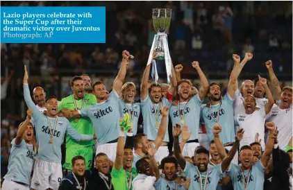  ??  ?? Lazio players celebrate with the Super Cup after their dramatic victory over Juventus Photograph: AP