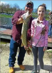  ?? SUBMITTED PHOTO ?? Emma McBride, and her father, James, display a 34-inch Muskie that Emma caught while fishing at Marsh Creek.