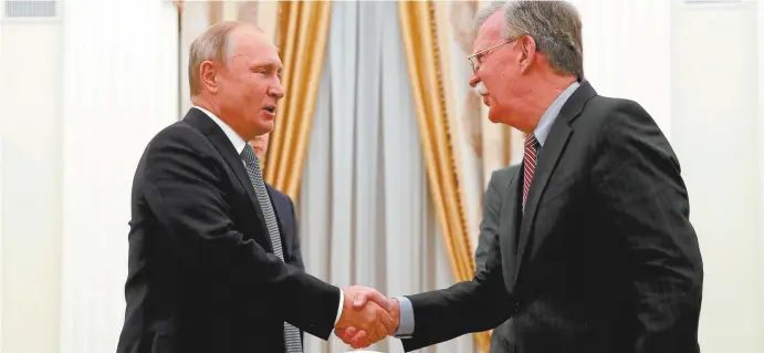  ??  ?? Vladimir Putin (left) with US National Security Adviser John Bolton in the Kremlin this week.