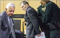  ?? LANNIS WATERS / THE PALM BEACH POST ?? Mark Barrow is handcuffed Monday in West Palm Beach after being convicted of the 2004 murder of Rae Tener. Barrow’s attorney, Peter Grable (left), said Barrow will appeal.