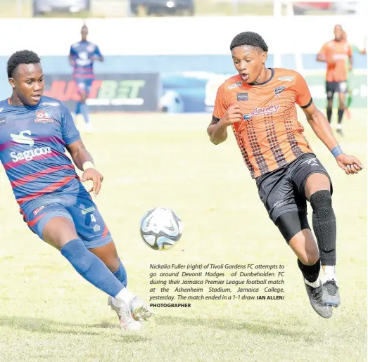  ?? PHOTOGRAPH­ER IAN ALLEN/ ?? Nickalia Fuller (right) of Tivoli Gardens FC attempts to go around Devonti Hodges of Dunbeholde­n FC during their Jamaica Premier League football match at the Ashenheim Stadium, Jamaica College, yesterday. The match ended in a 1-1 draw.