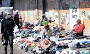  ?? | DOCTOR NGCOBO ?? MARKET REOPENS
STREET vendors have clothes laid out for sale in Greyville yesterday. The vendors only recently returned to selling clothes at the weekly Sunday flea market in the area after the easing of Covid-19 lockdown restrictio­ns.